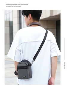 Detail of gray waterproof oxford nylon bag with dual zipper compartments and top handle