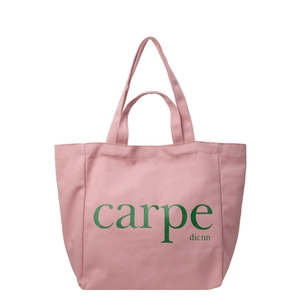 Minimalist pink canvas tote bag with green carpe text and dual handles for women