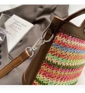 Detailed macro view of colorful woven straw bag texture and silver metal strap hooks