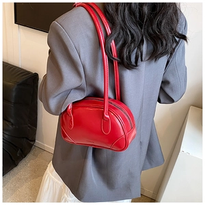 Chic vibrant red glossy PU shoulder bag paired with a gray suit for a stylish contrast