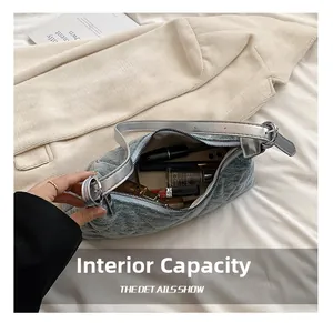 Internal capacity of the quilted denim crossbody bag showing daily makeup and phone storage