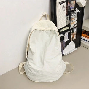 Minimalist beige nylon backpack with lightweight pleated texture for casual daily commuting