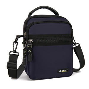 Detail of waterproof navy blue oxford nylon crossbody bag with Sport logo and zippers