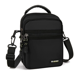 Detail showing durable black nylon material with multiple zipper compartments and SPORT logo