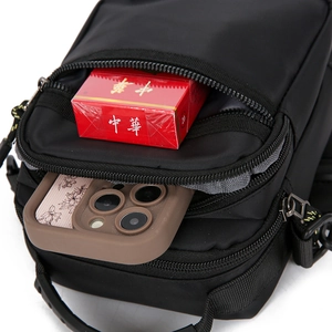Detail view of water-resistant oxford shoulder bag showing interior capacity and grey lining