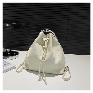 Versatile cream PU bucket bag with geometric patchwork and drawstring, used as crossbody or backpack