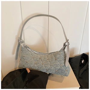 Vintage light blue denim crossbody bag with quilted diamond patterns and metal rivets