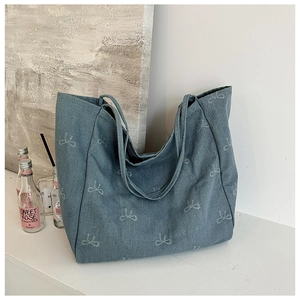 Blue denim tote bag with white bow embroidery and sturdy double top handles