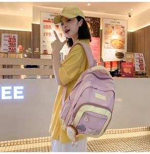 Pink and yellow nylon backpack with mesh pocket and cute plush toast keychain detail