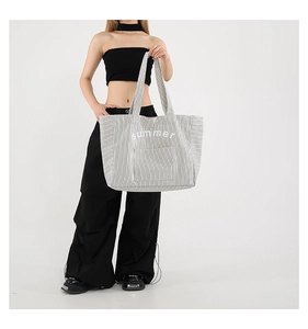 Black and white striped canvas tote bag featuring summer text and external pocket