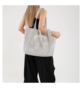 Detail of gray striped canvas tote bag with summer print and dual handle straps