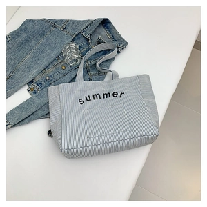 Striped blue and white summer tote bag for women with black summer text and denim jacket