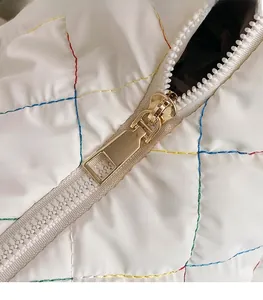 Detail of colorful quilted nylon fabric and high-quality gold metal zipper puller