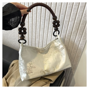 Elegant off-white jacquard fabric handbag with wooden bead handle and floral pattern