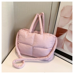 Light pink quilted nylon tote bag with wide padded squares and adjustable shoulder strap