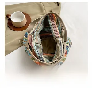 Top-down view of multi-color striped knitted bucket bag showing spacious interior capacity
