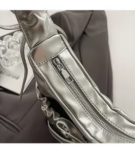 Close-up of silver PU leather crossbody bag featuring a smooth metal side zipper detail
