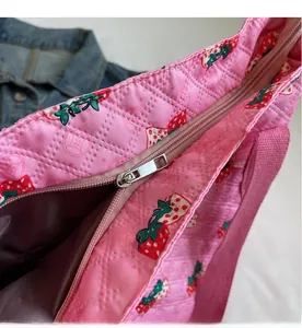 Detail view of the smooth pink strawberry canvas tote zipper and interior lining