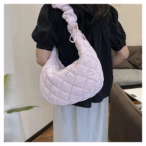 Detailed back view of a lavender quilted nylon half-moon hobo bag with puffy cloud strap