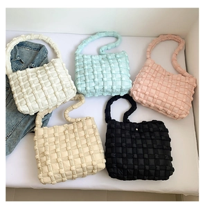 Detailed overhead view of quilted woven tote bags in five pastel and neutral colors