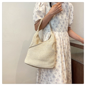 Detailed knit texture and leather trim of the cream white woven shoulder handbag