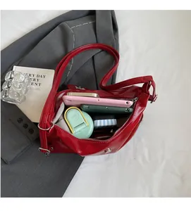 Detail view of red PU leather shoulder bag interior showing magnetic closure and wide capacity