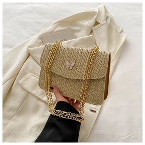 Chic straw woven crossbody bag with butterfly buckle and gold chain strap in beige