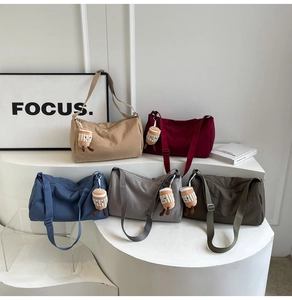 Detailed display of five canvas crossbody bags in various colors with cute plush charms