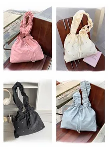 Detail view of nylon tote bags with ruffled straps and rhinestones in four colors