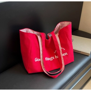 Red canvas tote bag with Good Things Happen print and striped lining for women