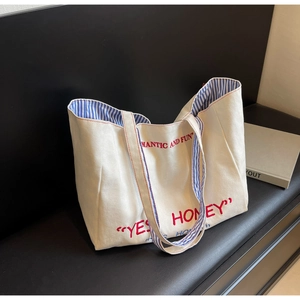 French style cream canvas tote bag with red Yes Honey text and blue striped lining