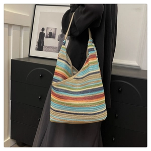 Detailed view of vibrant multi-colored striped knit tote bag texture and design