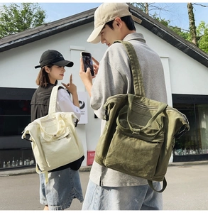 Outdoor shot of green and beige canvas backpacks shown on male and female models