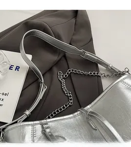 Detail showing the adjustable wide leather strap and metallic silver chain on the PU shoulder bag