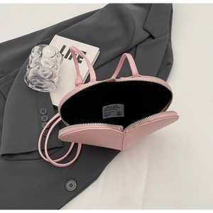 Dettaglio della borsa rosa a forma di cuore con fodera interna e cerniera argentata