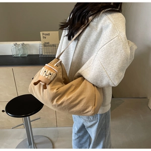 Detail of khaki crossbody bag in lightweight canvas with cute plush coffee cup charm