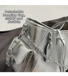 Detail of silver metallic PU crossbody bag featuring a durable detachable metal hook
