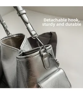 Detail of silver crackle PU tote with detachable shoulder strap and mini pouch charm
