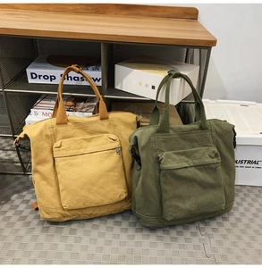 Close-up of canvas tote bags in yellow and green with front zipper pockets on wooden shelves