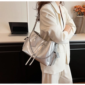 Detail of silver metallic PU tote bag with chain strap and soft pleated texture