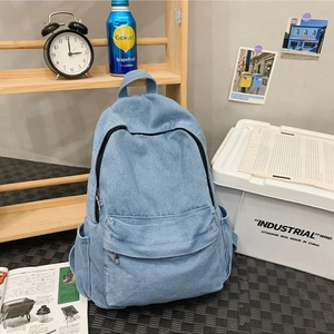 Light blue denim backpack for women featuring multiple pockets and a classic campus style