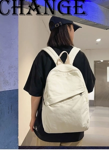 Detail view of large-capacity beige canvas backpack with minimalist hidden zipper design