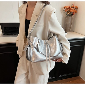 Close-up of silver PU crossbody bag with vintage crackle texture and chain detail