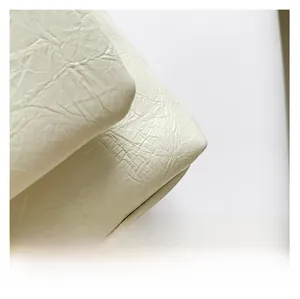 Close-up of premium white pleated PU leather texture for this elegant summer handbag