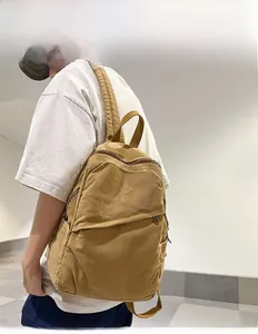 Brown corduroy backpack shown on model highlighting its textured finish and large capacity