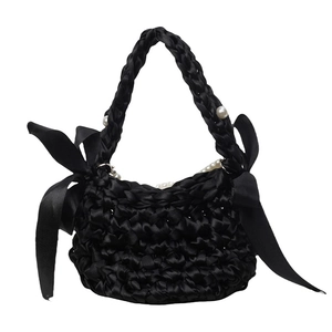 Minimalist black satin woven handbag with large side bows and elegant pearl handles