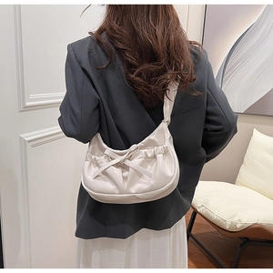 Detailed back view of a creamy white pleated moon bag with a bow knot design