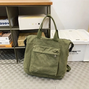 Army green canvas tote backpack with front pocket and adjustable side buckles