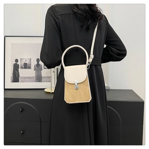 Detail view of khaki suede and cream PU leather handbag with silver metallic buckle