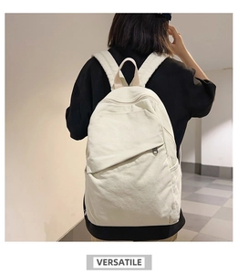 Detailed view of the off-white canvas backpack worn by a model in a minimalist setting
